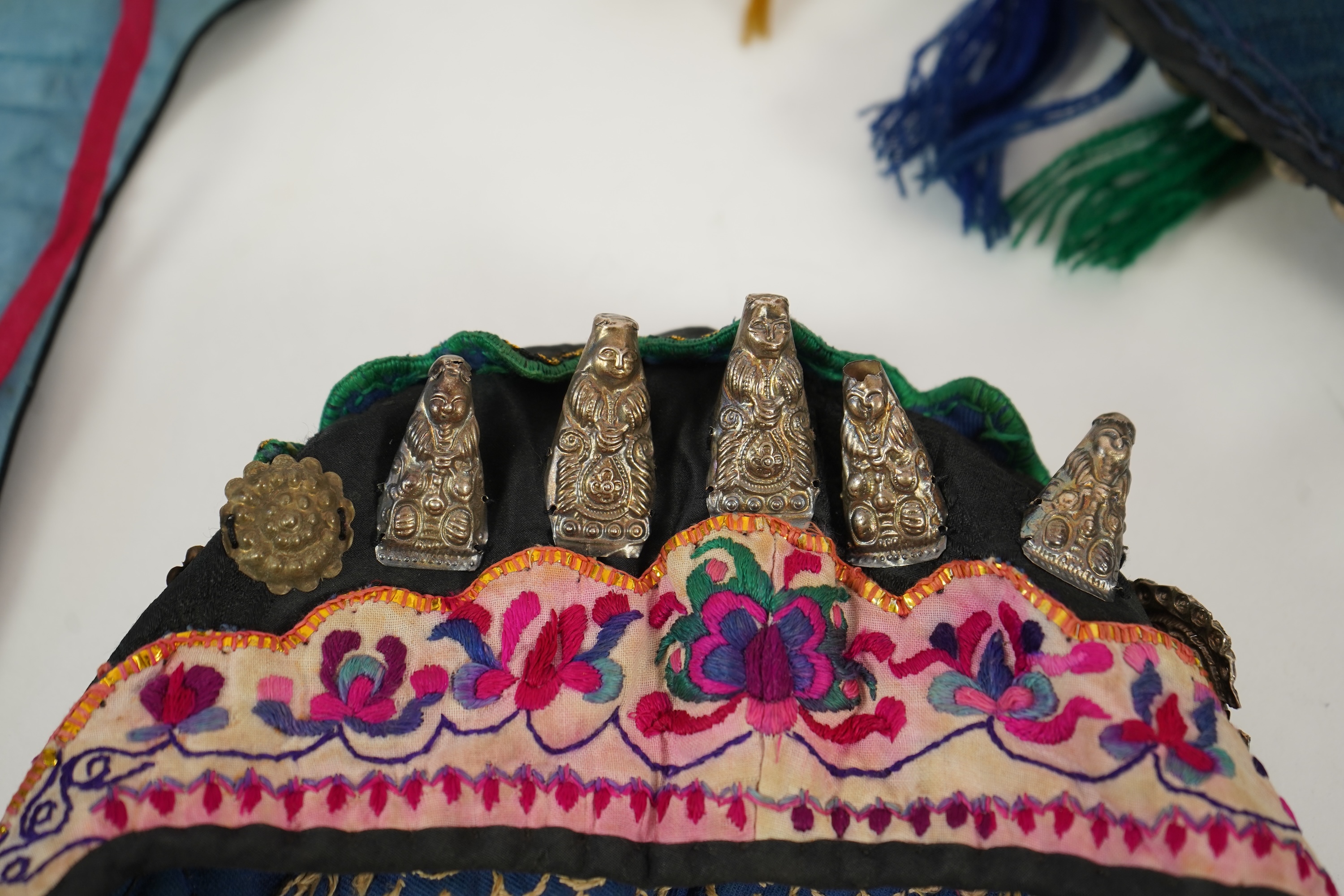 Two Chinese embroidered silk wedding skirts, late Qing, five hats, trousers, two skirt panels and two others, collar and a panel